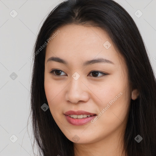 Joyful asian young-adult female with long  brown hair and brown eyes