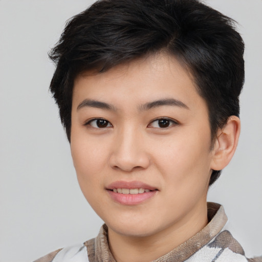 Joyful asian young-adult female with short  brown hair and brown eyes