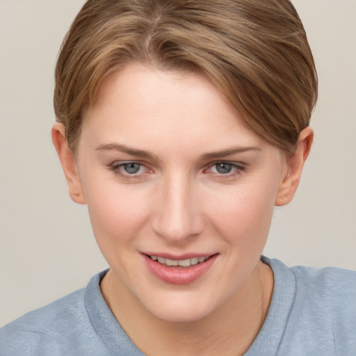 Joyful white young-adult female with short  brown hair and grey eyes