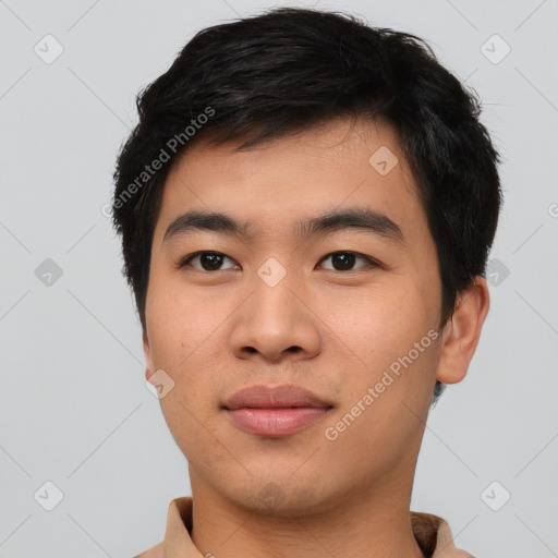 Joyful asian young-adult male with short  black hair and brown eyes