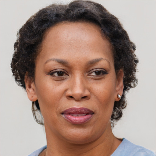 Joyful black adult female with short  brown hair and brown eyes