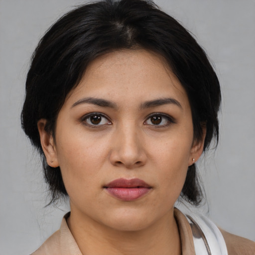 Joyful latino young-adult female with medium  black hair and brown eyes