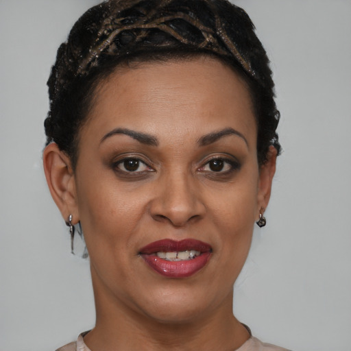 Joyful black young-adult female with short  brown hair and brown eyes