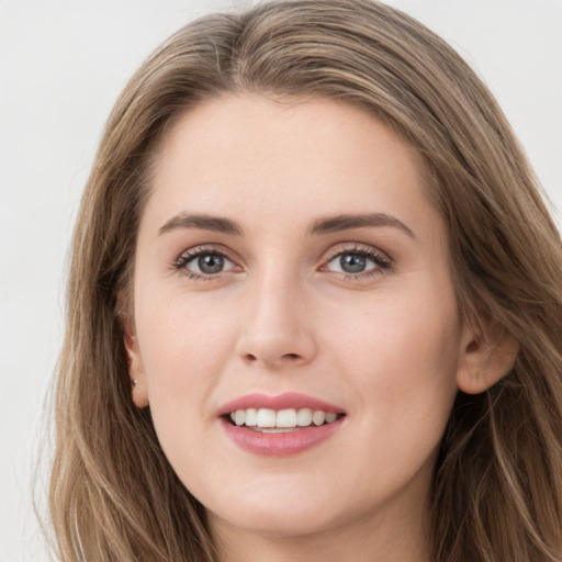 Joyful white young-adult female with long  brown hair and grey eyes