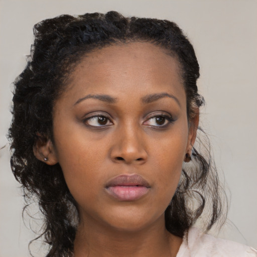Neutral black young-adult female with medium  black hair and brown eyes
