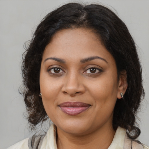 Joyful black young-adult female with medium  brown hair and brown eyes