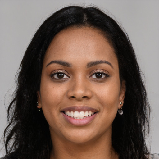 Joyful latino young-adult female with long  black hair and brown eyes
