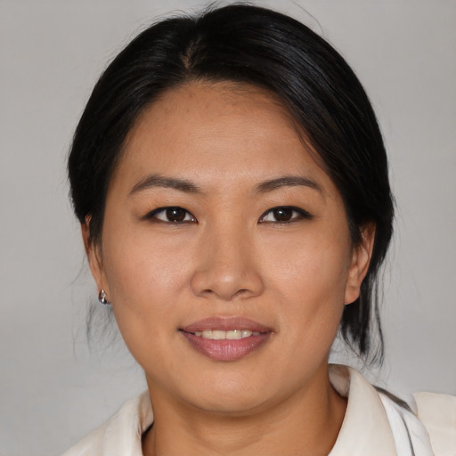 Joyful asian young-adult female with medium  brown hair and brown eyes