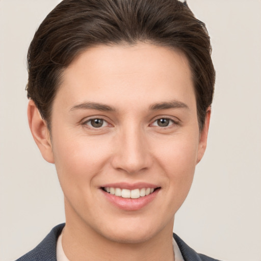 Joyful white young-adult female with short  brown hair and grey eyes