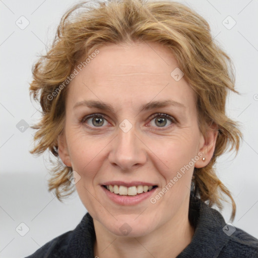 Joyful white adult female with medium  brown hair and blue eyes