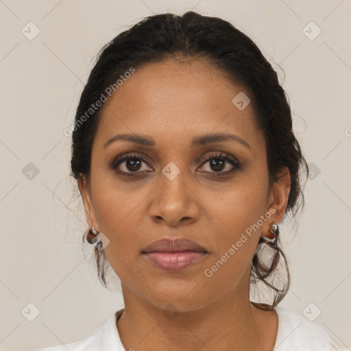 Joyful black adult female with medium  brown hair and brown eyes