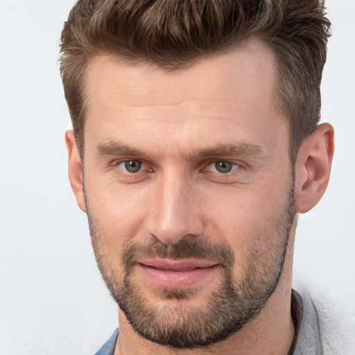 Joyful white adult male with short  brown hair and brown eyes