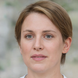 Joyful white young-adult female with medium  brown hair and blue eyes