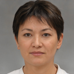 Joyful white adult female with short  brown hair and brown eyes