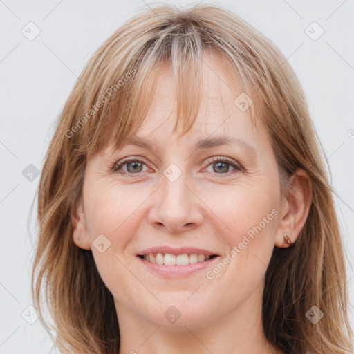 Joyful white adult female with long  brown hair and grey eyes