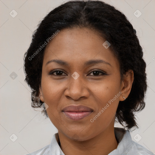 Joyful black adult female with medium  brown hair and brown eyes