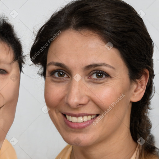 Joyful white adult female with medium  brown hair and brown eyes