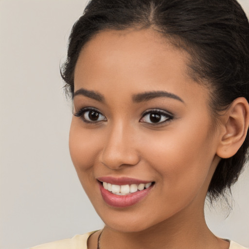 Joyful latino young-adult female with long  brown hair and brown eyes