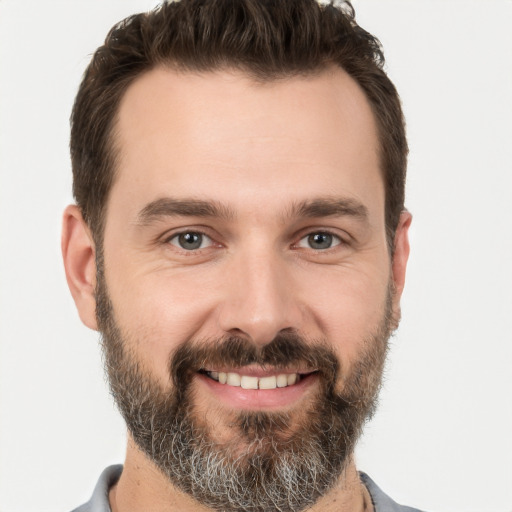 Joyful white young-adult male with short  brown hair and brown eyes