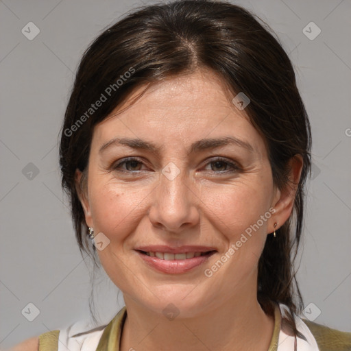 Joyful white adult female with medium  brown hair and brown eyes