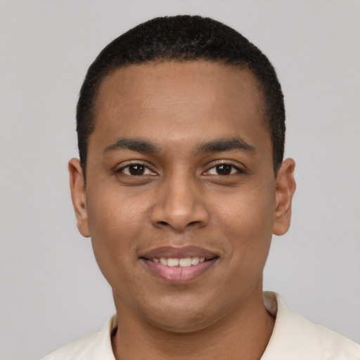 Joyful black young-adult male with short  black hair and brown eyes