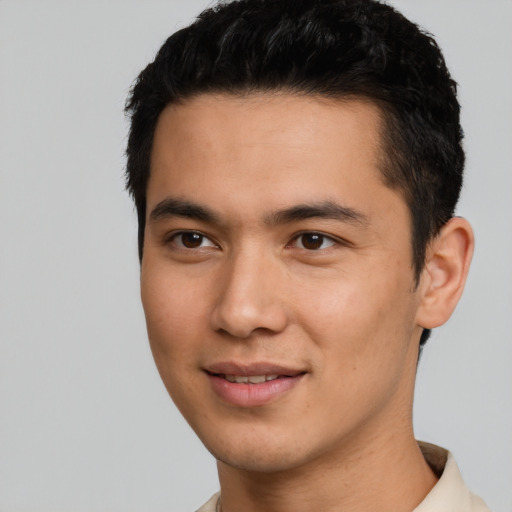 Joyful asian young-adult male with short  black hair and brown eyes