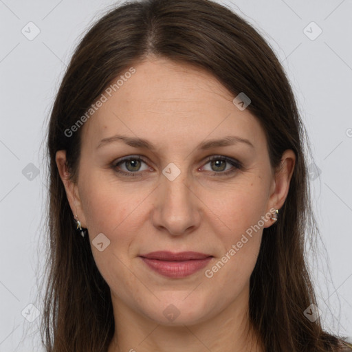 Joyful white adult female with long  brown hair and grey eyes