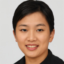 Joyful asian young-adult female with short  black hair and brown eyes