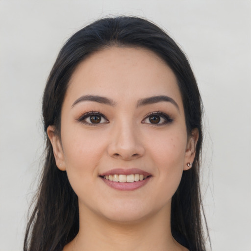 Joyful asian young-adult female with long  brown hair and brown eyes