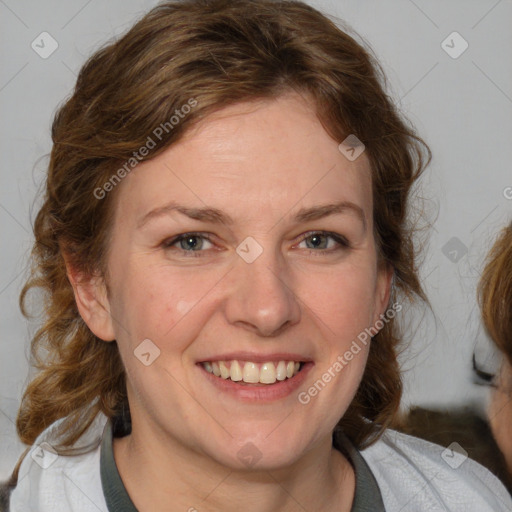 Joyful white adult female with medium  brown hair and blue eyes