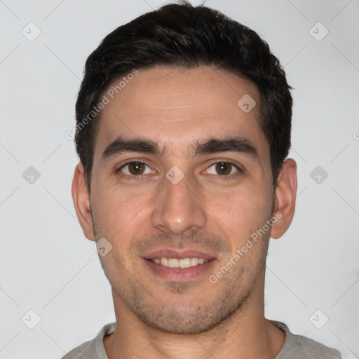 Joyful white young-adult male with short  black hair and brown eyes