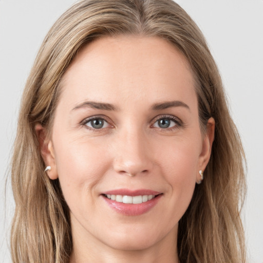 Joyful white young-adult female with long  brown hair and grey eyes