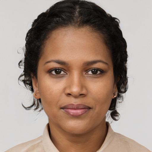 Joyful black young-adult female with medium  brown hair and brown eyes