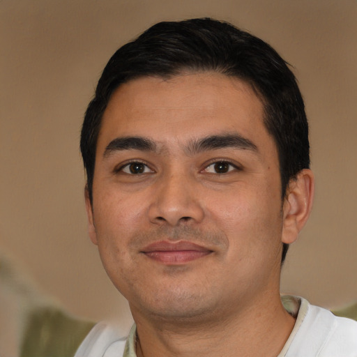 Joyful latino young-adult male with short  brown hair and brown eyes