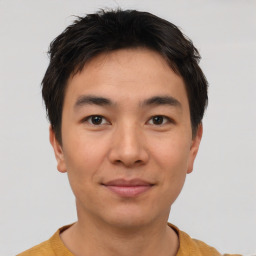 Joyful asian young-adult male with short  brown hair and brown eyes