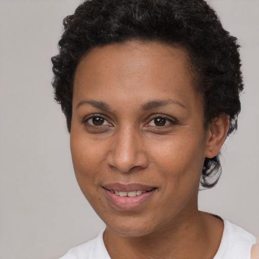 Joyful black young-adult female with short  brown hair and brown eyes