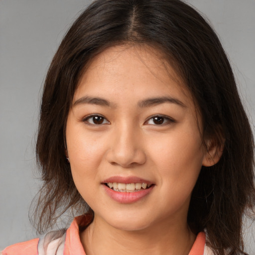 Joyful white young-adult female with medium  brown hair and brown eyes