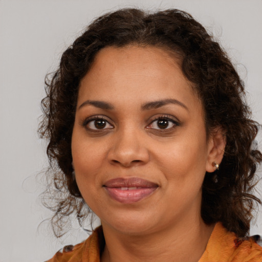 Joyful black young-adult female with medium  brown hair and brown eyes
