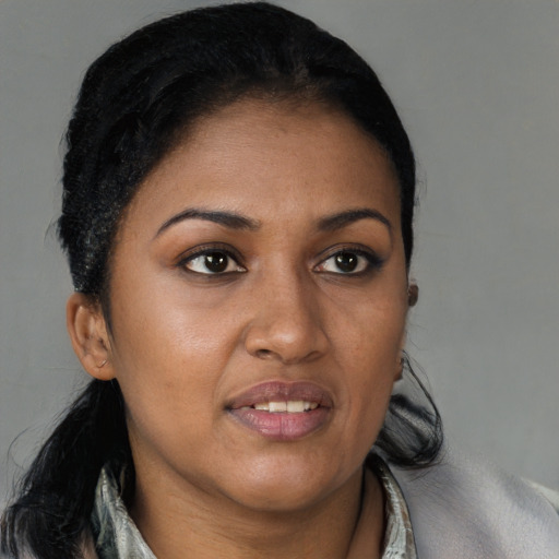 Joyful black young-adult female with medium  brown hair and brown eyes