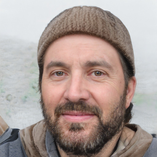 Joyful white adult male with short  black hair and brown eyes