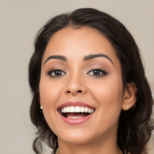 Joyful white young-adult female with medium  black hair and brown eyes