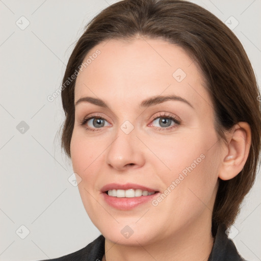 Joyful white young-adult female with medium  brown hair and grey eyes