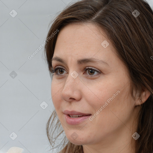 Joyful white adult female with long  brown hair and brown eyes