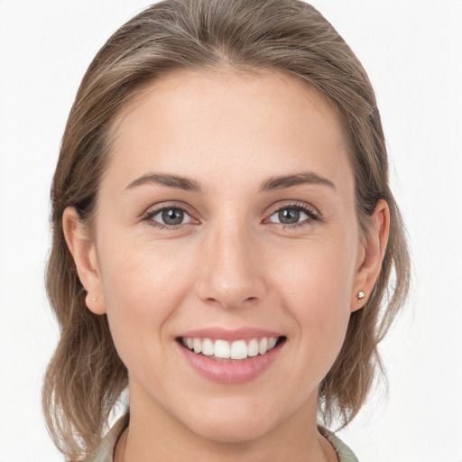 Joyful white young-adult female with medium  brown hair and grey eyes