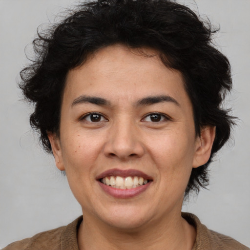 Joyful asian adult female with medium  brown hair and brown eyes