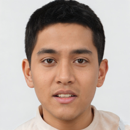 Joyful latino young-adult male with short  black hair and brown eyes