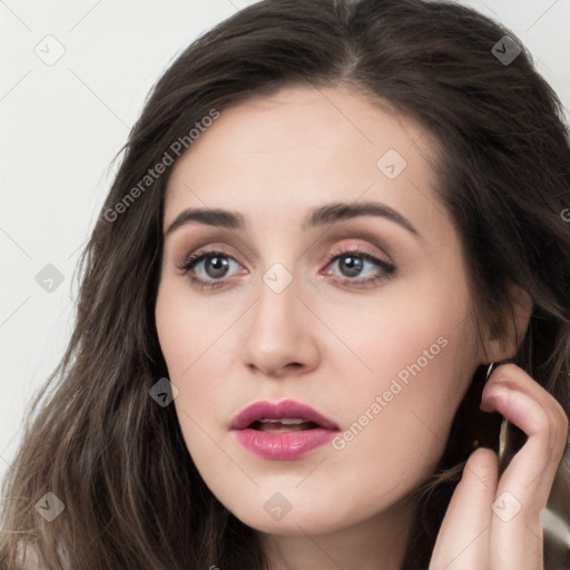 Neutral white young-adult female with long  brown hair and brown eyes