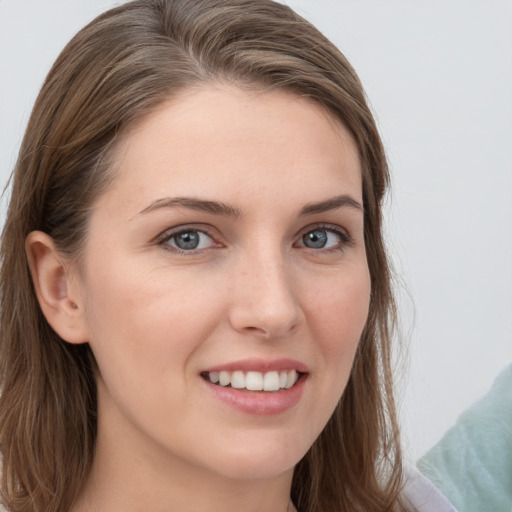 Joyful white young-adult female with long  brown hair and grey eyes