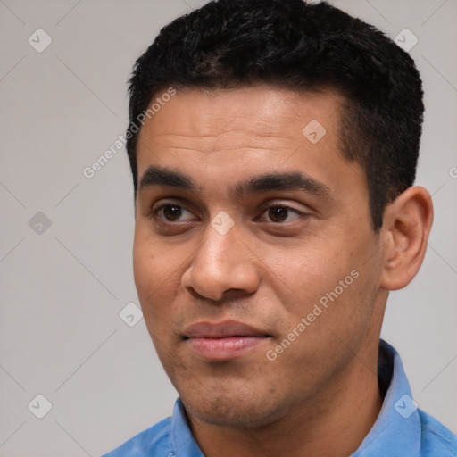 Joyful latino young-adult male with short  black hair and brown eyes