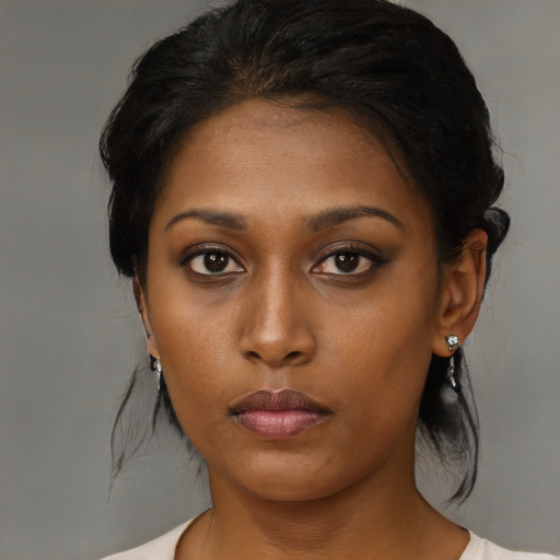 Neutral black young-adult female with medium  brown hair and brown eyes